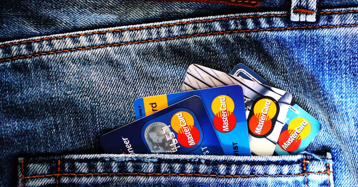 Close-up of a denim pocket with multiple credit cards, illustrating finance and fashion.