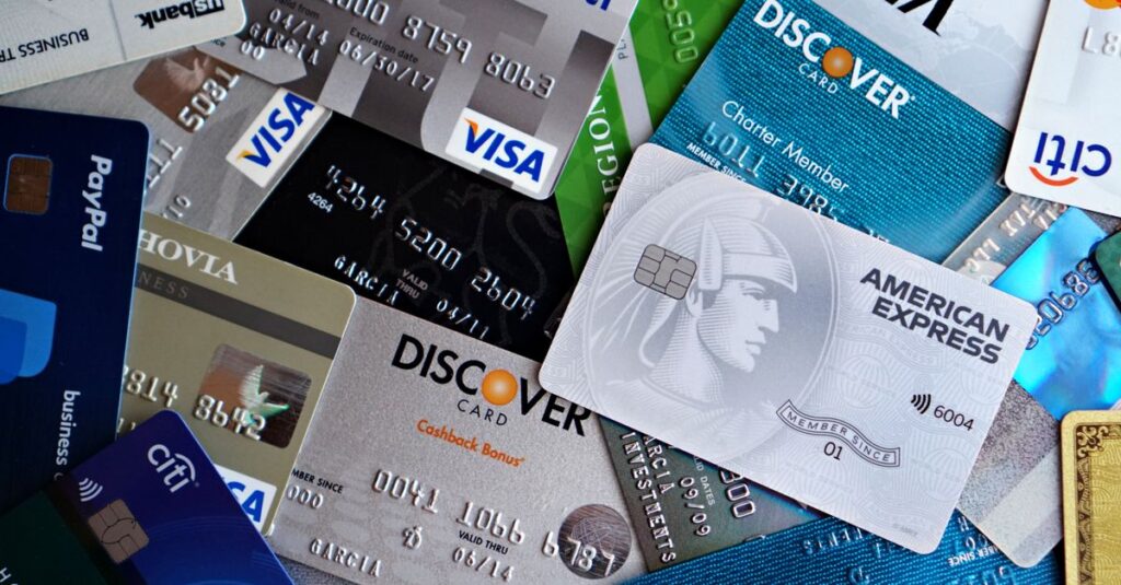 A flat lay of assorted credit and debit cards from various banks. Ideal for finance and banking concepts.