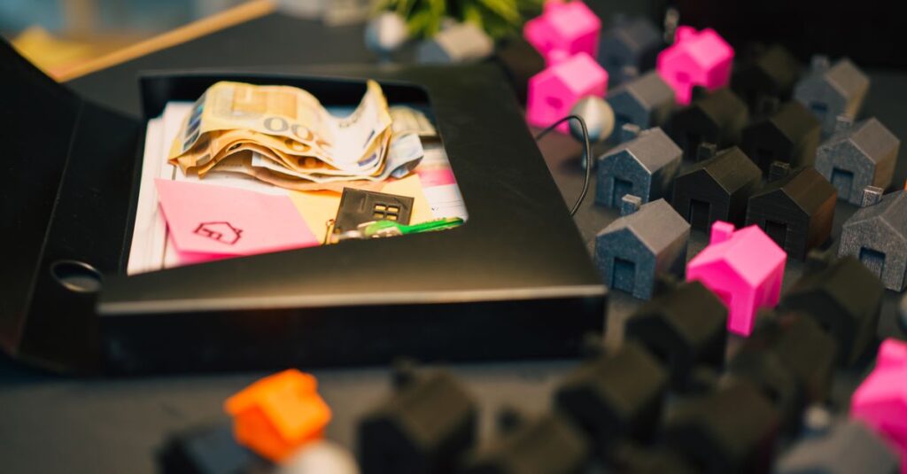 Real estate investment concept with money and house models on table.