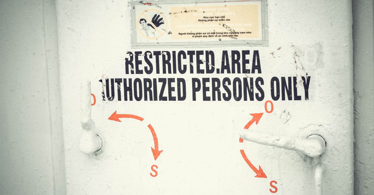 Close-up of a restricted area door with signage emphasizing authorized access only.