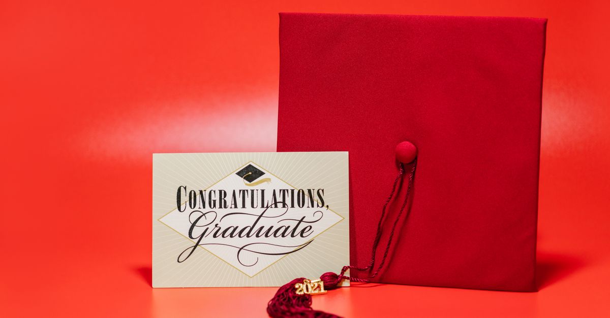 A red graduation cap with a congratulations card, symbolizing achievement and celebration.